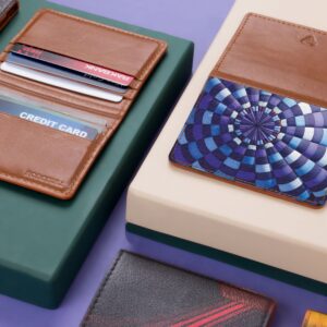 Close-up of assorted leather wallets and cardholders on a modern violet and green background.